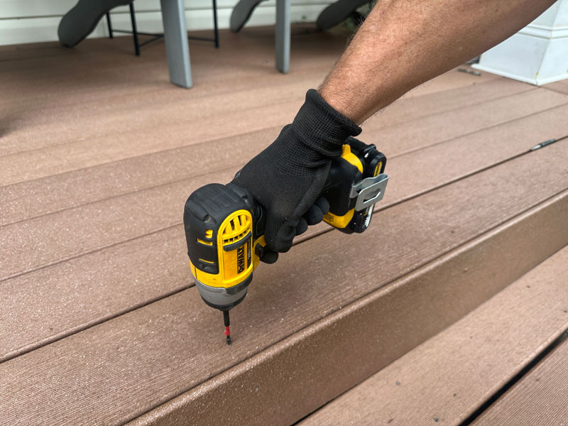 Installing composite decking boards with a drill